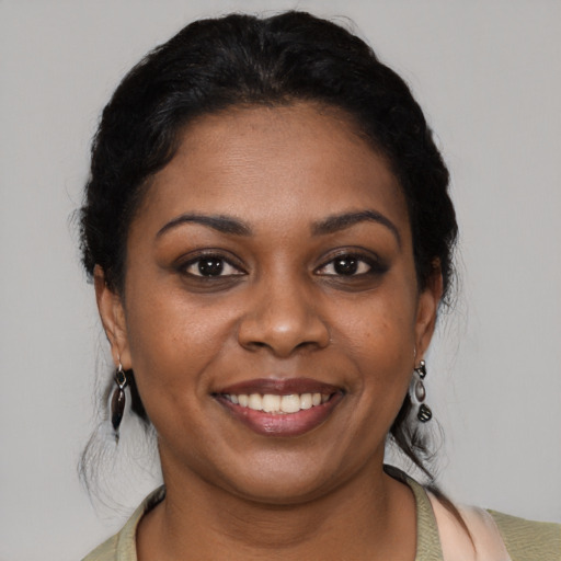 Joyful black young-adult female with medium  black hair and brown eyes