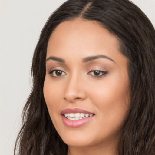 Joyful white young-adult female with long  black hair and brown eyes