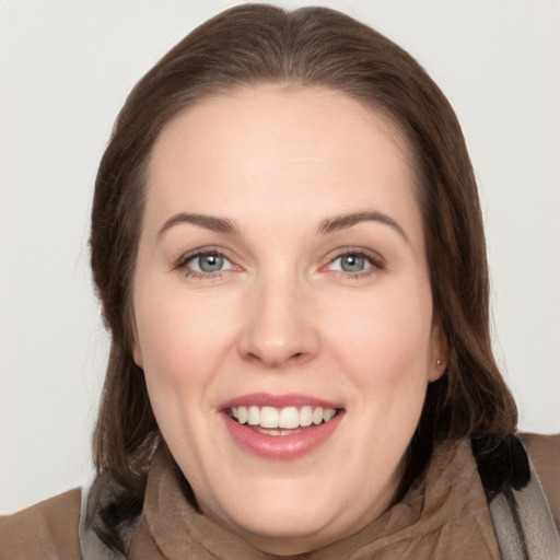 Joyful white young-adult female with long  brown hair and grey eyes