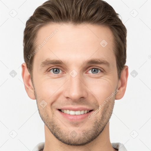 Joyful white young-adult male with short  brown hair and grey eyes