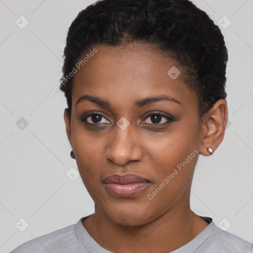 Joyful black young-adult female with short  black hair and brown eyes