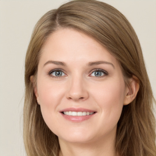 Joyful white young-adult female with long  brown hair and grey eyes