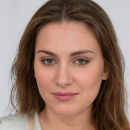 Joyful white young-adult female with long  brown hair and green eyes