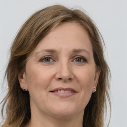 Joyful white adult female with long  brown hair and grey eyes