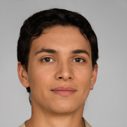 Joyful latino young-adult male with short  brown hair and brown eyes