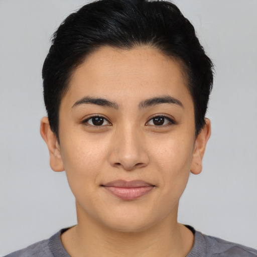 Joyful asian young-adult female with short  black hair and brown eyes