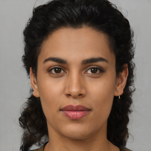 Joyful latino young-adult female with medium  brown hair and brown eyes