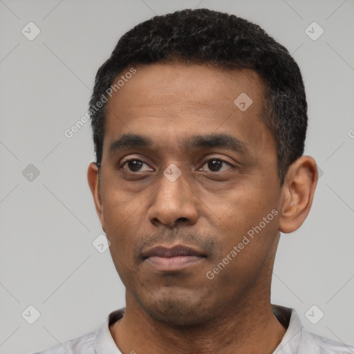 Neutral latino young-adult male with short  black hair and brown eyes