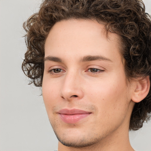 Joyful white young-adult male with medium  brown hair and brown eyes