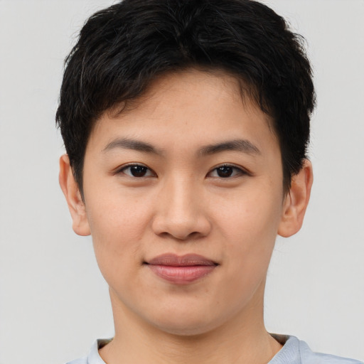 Joyful asian young-adult female with short  brown hair and brown eyes