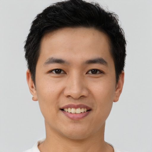 Joyful asian young-adult male with short  black hair and brown eyes