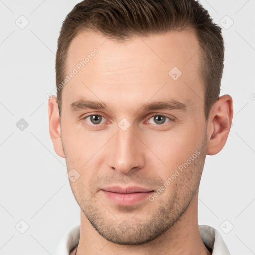 Joyful white young-adult male with short  brown hair and brown eyes