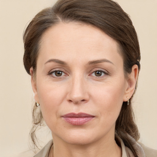 Joyful white adult female with medium  brown hair and grey eyes