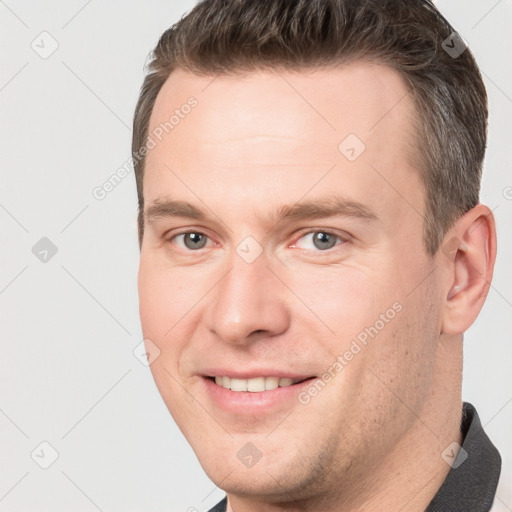 Joyful white adult male with short  brown hair and brown eyes