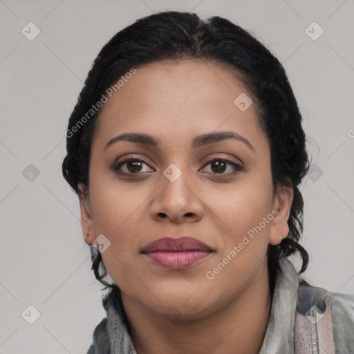 Joyful black young-adult female with long  black hair and brown eyes