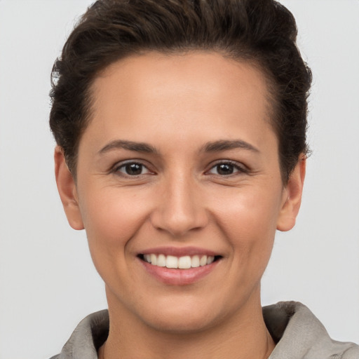 Joyful white young-adult female with short  brown hair and brown eyes