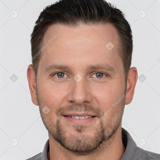 Joyful white adult male with short  brown hair and brown eyes