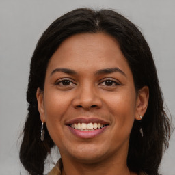 Joyful latino young-adult female with medium  brown hair and brown eyes