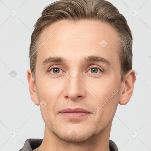 Joyful white young-adult male with short  brown hair and grey eyes