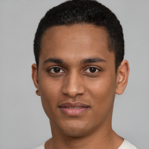 Joyful black young-adult male with short  black hair and brown eyes