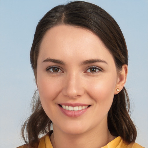 Joyful white young-adult female with medium  brown hair and brown eyes