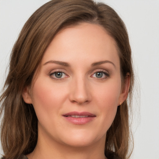 Joyful white young-adult female with long  brown hair and green eyes