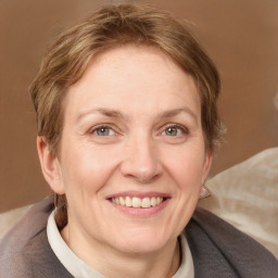 Joyful white adult female with short  brown hair and grey eyes