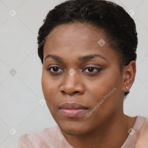 Joyful black young-adult female with short  black hair and brown eyes