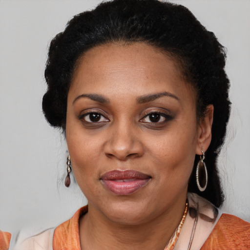 Joyful latino adult female with long  black hair and brown eyes