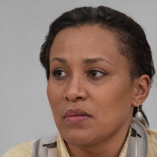 Joyful black adult female with short  brown hair and brown eyes