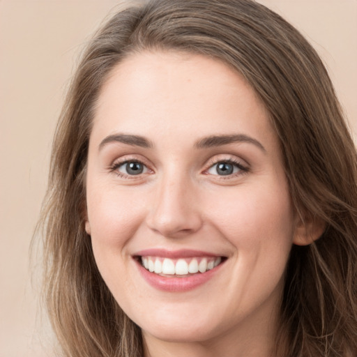 Joyful white young-adult female with long  brown hair and grey eyes