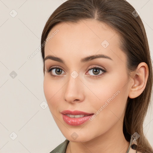 Joyful white young-adult female with long  brown hair and brown eyes