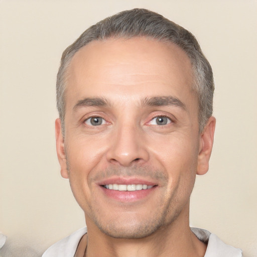 Joyful white adult male with short  black hair and brown eyes