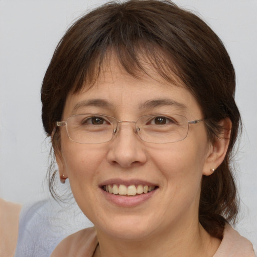 Joyful white adult female with medium  brown hair and brown eyes