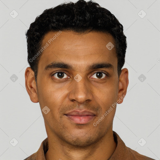 Joyful black young-adult male with short  black hair and brown eyes