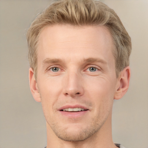 Joyful white adult male with short  brown hair and grey eyes