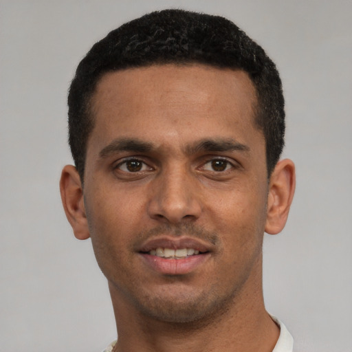 Joyful white young-adult male with short  black hair and brown eyes