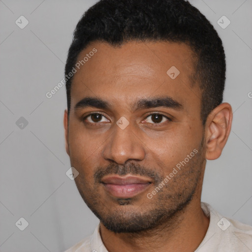 Joyful black young-adult male with short  black hair and brown eyes