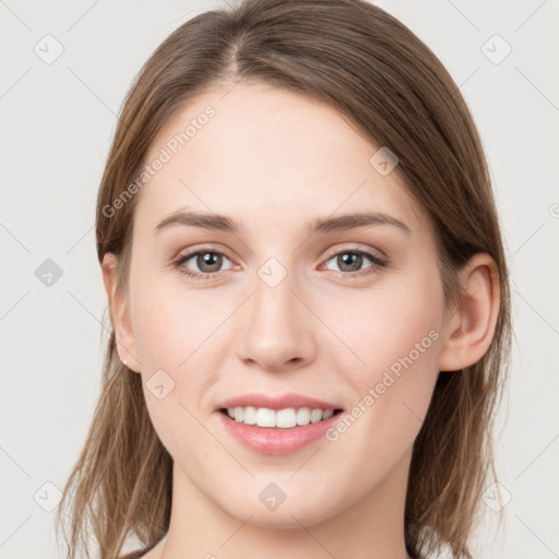 Joyful white young-adult female with medium  brown hair and grey eyes