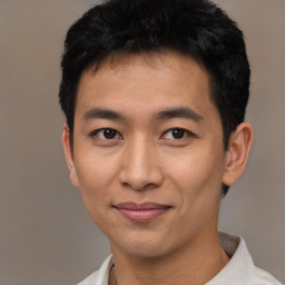 Joyful asian young-adult male with short  black hair and brown eyes