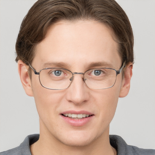 Joyful white adult male with short  brown hair and grey eyes