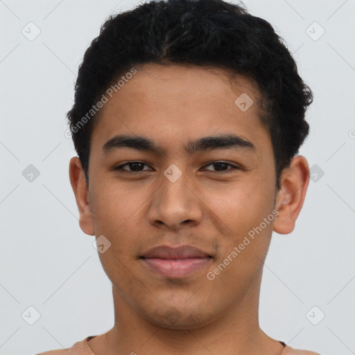 Joyful latino young-adult male with short  brown hair and brown eyes