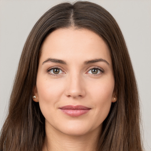 Joyful white young-adult female with long  brown hair and brown eyes