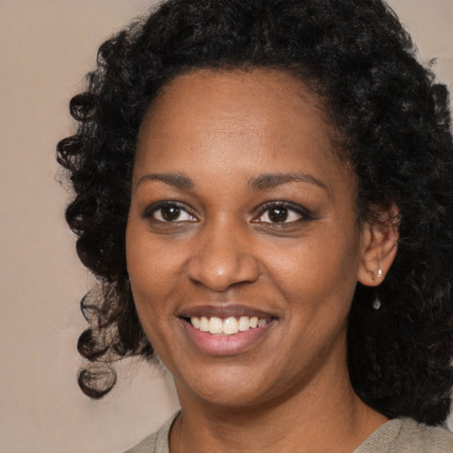 Joyful black young-adult female with medium  black hair and brown eyes