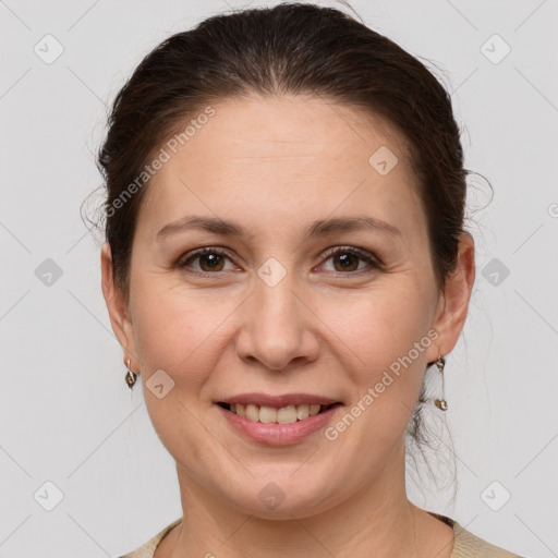 Joyful white adult female with short  brown hair and grey eyes