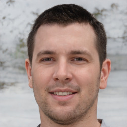 Joyful white young-adult male with short  brown hair and brown eyes