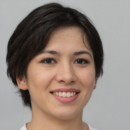 Joyful asian young-adult female with short  brown hair and brown eyes