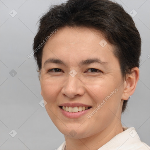 Joyful white adult female with short  brown hair and brown eyes