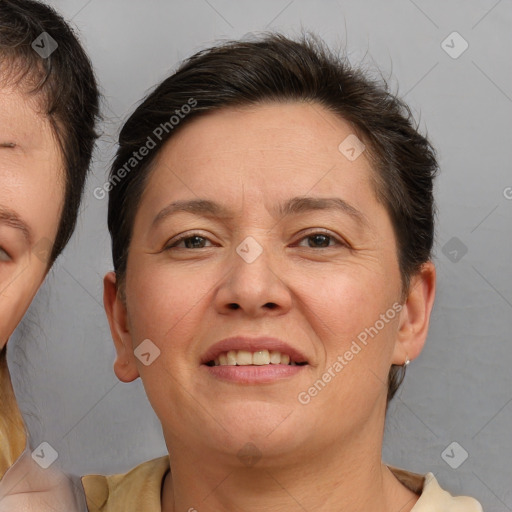 Joyful white adult female with medium  brown hair and brown eyes