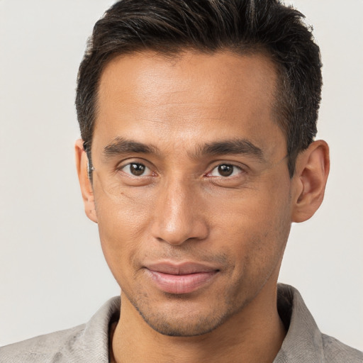 Joyful white adult male with short  brown hair and brown eyes